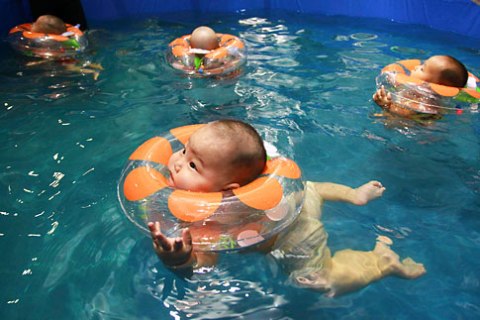 A group of Chinese babies take part in a swimming contest at the National Swimming center in Beijing, on Sept. 22, 2012.